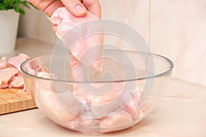 Defrosted raw chicken fillet in glass bowl. Fresh raw chicken breast for cooking chopped chicken cutlets. Glass bowl and