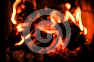 Defused abstract image. three burning billets in hot stove.Fire flame burning coal and wood in fireplace.Hot coals in