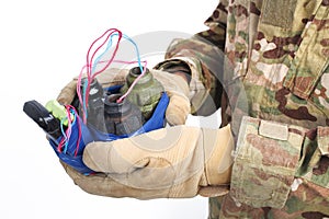 defused improvised explosive device (IED) in hand