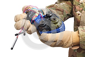 defused improvised explosive device (IED) in hand