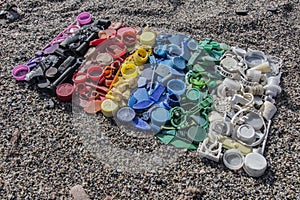 Degraded still life of plastic caps and different plastic pieces found on the beach