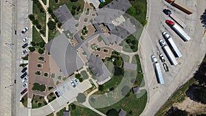 90-degree aerial view row of semi-truck, trailers, logistic containers parked at truck stops in Highway Interstate 10 rest area,