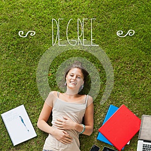 Degree against pretty student lying on grass