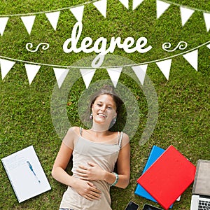 Degree against pretty student lying on grass