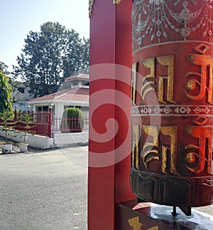 Dehradun, India: Prayer wheel with bell with language of Tibetan, A cylindrical wheel, mantra Om Mani Padme Hum , Vertical image,