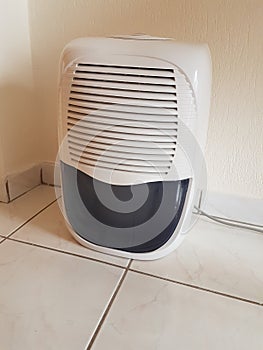 dehumidifier on the floor white red plastic