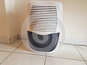 dehumidifier on the floor white red plastic