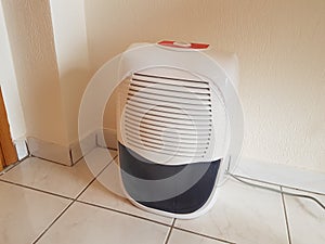 dehumidifier on the floor white red plastic