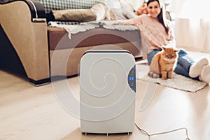 Dehumidifier with touch panel, humidity indicator, uv lamp, air ionizer, water container works at home. Dampness photo