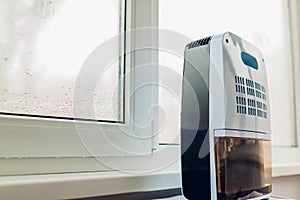 Dehumidifier with touch panel, humidity indicator, uv lamp, air ionizer, water container works by wet window