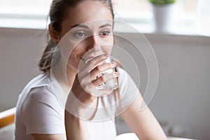 Dehydrated woman is drinking pure mineral water