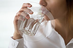 Dehydrated woman feeling thirsty holding glass drinking water, h