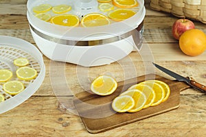 Dehydration machine with orange slices on kitchen table