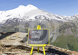DEI diversity equality inclusion symbol. Concept words DEI diversity equality inclusion on yellow blackboard. Beautiful Elbrus