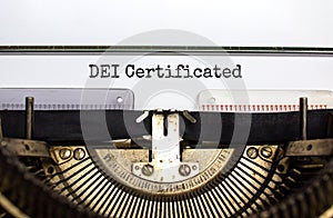 DEI, diversity equity inclusion certificated symbol. Concept words `DEI certificated` typed on old retro typewriter. Business, D