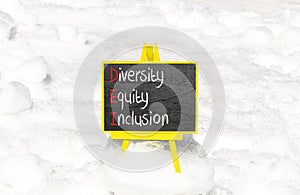 DEI diversity equity and inclusion symbol. Concept words DEI diversity equity inclusion on blackboard. Beautiful white snow