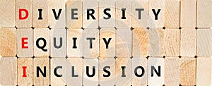 DEI diversity equity and inclusion symbol. Concept words DEI diversity equity inclusion on blocks on beautiful wooden background.