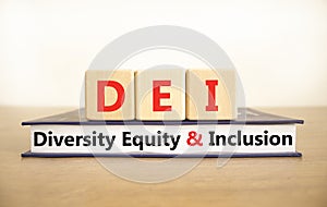 DEI diversity equity and inclusion symbol. Concept words DEI diversity equity and inclusion on blocks book. Beautiful white