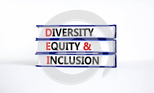 DEI diversity equity and inclusion symbol. Concept words DEI diversity equity and inclusion on books. beautiful white background.