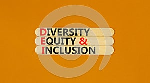 DEI diversity equity and inclusion symbol. Concept words DEI diversity equity and inclusion on stick. Beautiful orange background