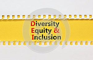 DEI diversity equity and inclusion symbol. Concept words DEI diversity equity and inclusion on yellow paper. Beautiful white