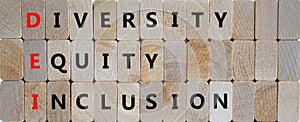 DEI, Diversity, equity, inclusion symbol. Wooden blocks with words DEI, diversity, equity, inclusion on beautiful wooden