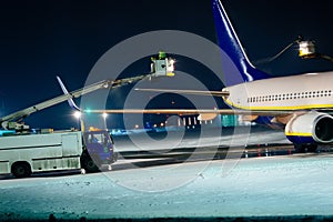 Deicing passenger airplane during heavy snow