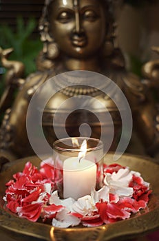 Deity Sculpture with flower petals photo