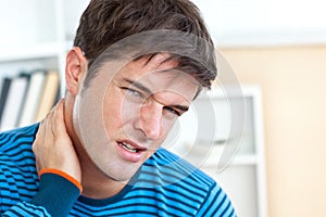 Dejected caucasian man having a neck ache