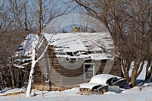 Delapidated car and cabin in winter