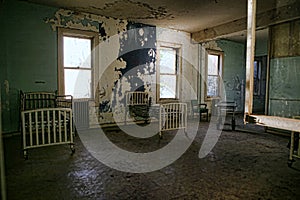 Delapidated Hospital Building With Empty Rusted Beds