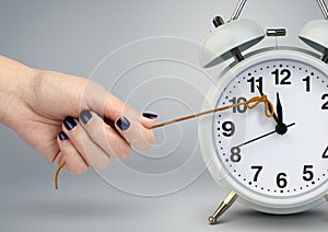 Delay concept, time on alarm clock stop by hand photo