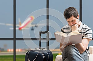 Delayed aeroplane concept. Man is sitting with baggage in airport