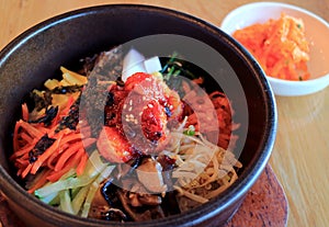 Delectable Bibimbap, a Korean Traditional Mixed Rice with Meat and Assorted Vegetables in Hot Stone Bowl