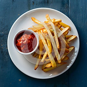 Delectable french fry served with tomato sauce