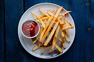 Delectable french fry served with tomato sauce