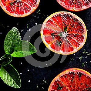 A delectable grilled grapefruit half, topped with a sprinkle of brown sugar and a sprig of fresh mint,