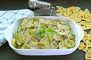 Homemade Farfalle Pasta with Pesto Sauce on Kitchen Table