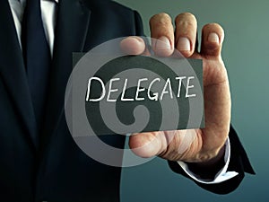 Delegate sign in the hands of the businessman. Delegation concept photo