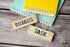 delegate task symbol. Concept words return on assets on wooden blocks