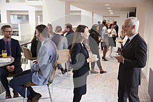 Delegates Networking During Coffee Break At Conference