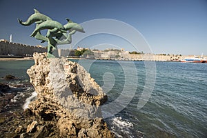 Delfini Dolphins statue Rhodes town Harbour harbor