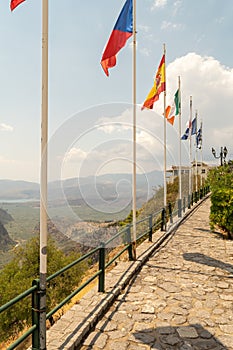 Delfoi road in Greece with flags from countries.