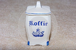 Delft Blue Coffee Koffie container. Famous porcelain souvenirs from Holland/Netherlands.  on textured beige background
