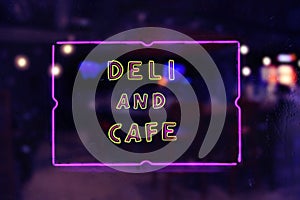Deli and Cafe Neon Sign in Rainy Window
