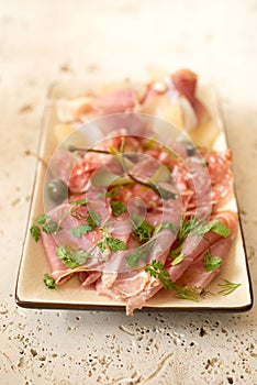 Deli or Lunch Meat and Greens in a Rectangular Plate