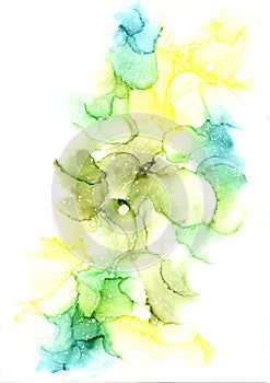 Delicate abstract hand drawn watercolor or alcohol ink background in different tones of green and yellow.