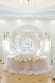 Delicate airy wedding decor in the restaurant. Table newlywed