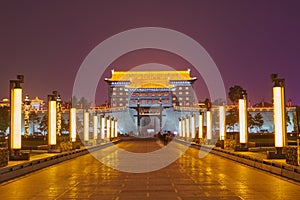 The delicate ancient city wall tower with light at night photo