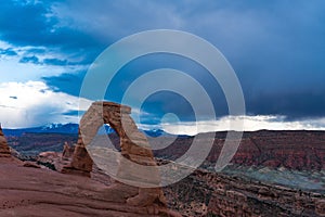 Delicate arch in Arches national Park, beneath a stormy sky